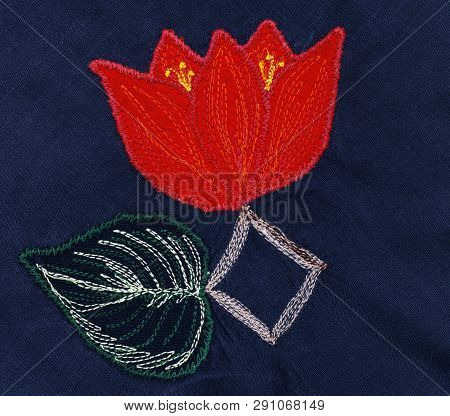 Red Flower With Leaf. Applique On Gark Blue Fabric.