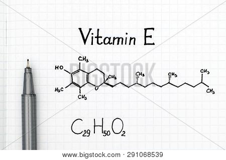 Chemical Formula Of Vitamin E With Black Pen. Close-up.