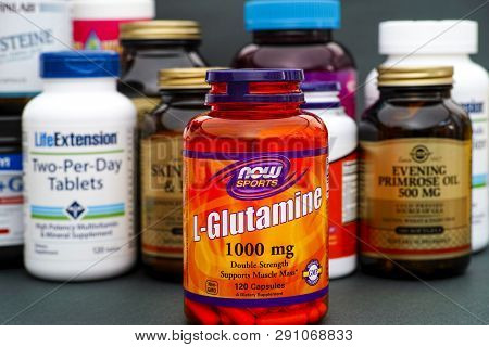 Tambov, Russian Federation - August 22, 2017 Bottle With L-glutamine By Now Sports. Some Bottles Wit