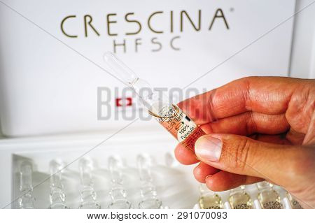 Paphos, Cyprus - November 13, 2015 Woman Hand With Ampoule Of Crescina Hfsc Re-growth Formula In Fro