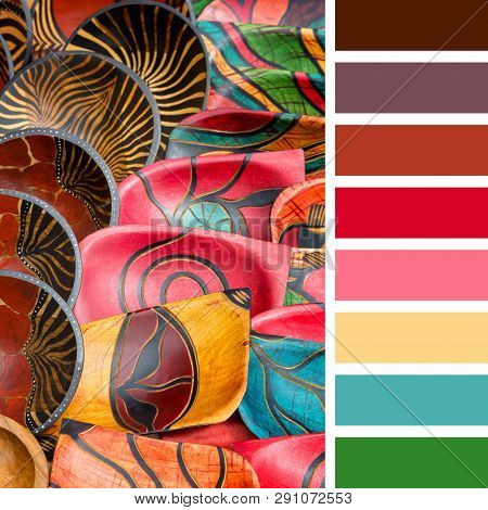 Decorative painted African carved wood bowls. In a colour palette with complimentary colour swatches. These bowls are generic and of the kind found at souvenir stalls across Africa