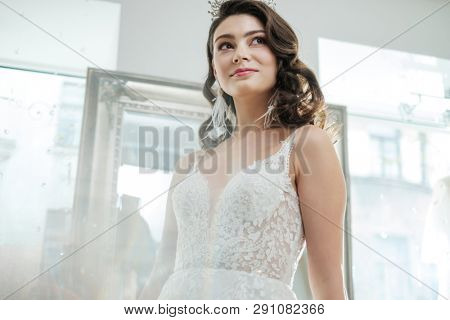 Beautifu bride choosing wedding dress in a wedding salon