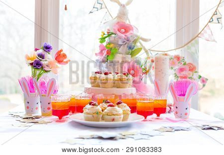 Dessert Table With Cupcakes And Flowers Easter Party Theme