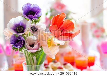 Vase Of Spring Flowers On A Dessert Table