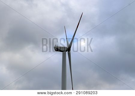 View On Alternative Energy Windmills In A Windpark In Northern Germany In Front Of A Blue Sky