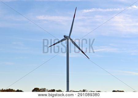 View On Alternative Energy Windmills In A Windpark In Northern Germany In Front Of A Blue Sky