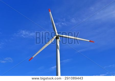 View On Alternative Energy Windmills In A Windpark In Northern Germany In Front Of A Blue Sky