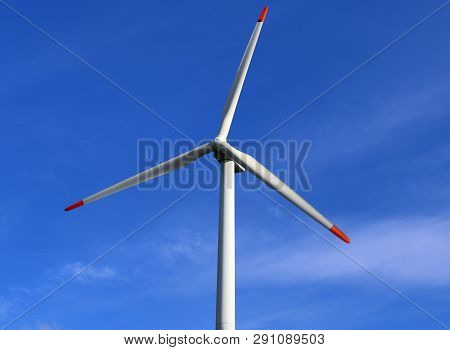 View On Alternative Energy Windmills In A Windpark In Northern Germany In Front Of A Blue Sky