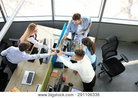Top View Of Young Modern Colleagues In Smart Casual Wear Working Together While Spending Time In The