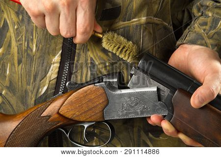 Hunter Cleans The Barrels Of His Shotgun With A Ramrod, Closeup