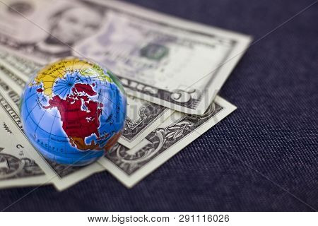 Concept Of Travel, Small Globe On Background Of Dollars