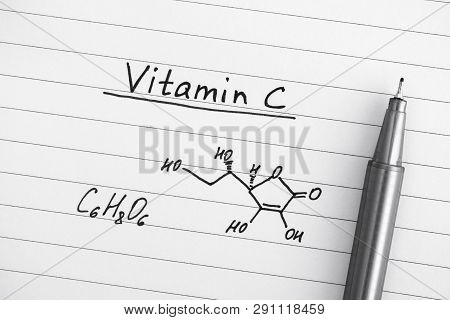 Chemical Formula Of Vitamin C With Pen. Close-up.