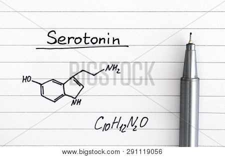 Chemical Formula Of Serotonin On Lined Paper With Pen. Close-up.