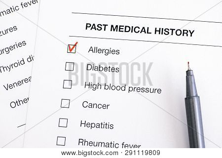 Past Medical History Questionary With Ticked Allergies And Pen. Close-up.