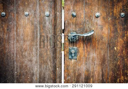 Wooden Gate With Door Knob And Keyhole. Close-up.