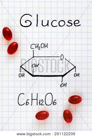 Chemical Formula Of Glucose With Red Pills. Close-up.