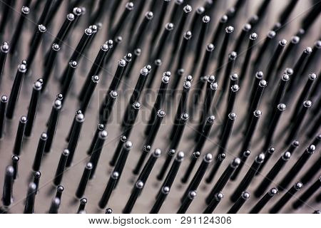 Close-up Of Bristles On Black Hairbrush. Full Frame.