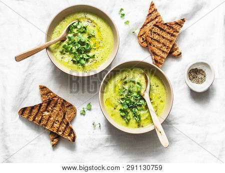 Mashed Spring Vegetable Soup Served With Micro Greens And Whole Grain Crackers On A Light Background