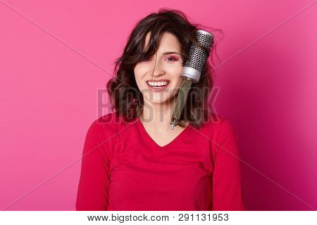 Photo Of Dark Haired Girl Combs Her Hair, Has Some Problems, Hairbrush Tangled In Curls, Stands Smil