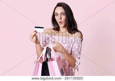 Shocked European Woman Holds Bags, Keeps Her Lips Rounded, Astonished To Recieve Unlimited Plastic C