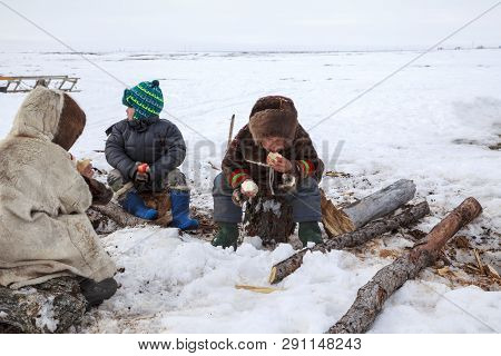 Nadym, Russia - April 27, 2018: Tundra, Open Area, The Boys In National Clothes In Cold Winter Weath
