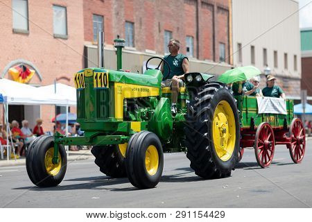 Jasper, Indiana, Usa - August 5, 2018: The Strassenfest Parade, Man Driving An Old Tractor, Pulling 