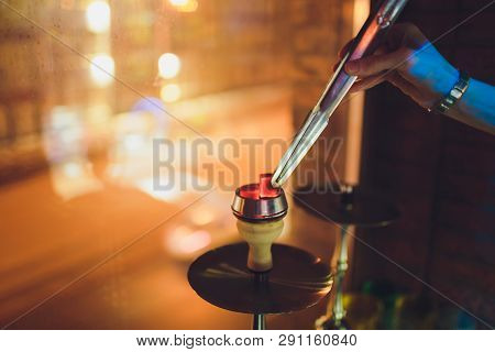 Shisha Bowl With Craft Tobacco And Red Coil With Hookah Smoke Background.