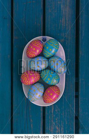 Colored Easter Eggs On A White Plate, Blue Wooden Bench, Amsterdam The Netherlands, 23 March 2019