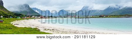 Summer Cloudy View Of The Beach With White Sand In Ramberg (norway, Lofoten). People Unrecognizable.