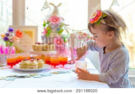 Little Toddler Girl Eating Dessert After Easter Dinner