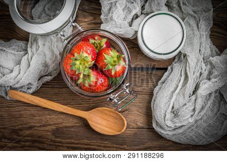 Strawberry In Jar On Wooden Background.