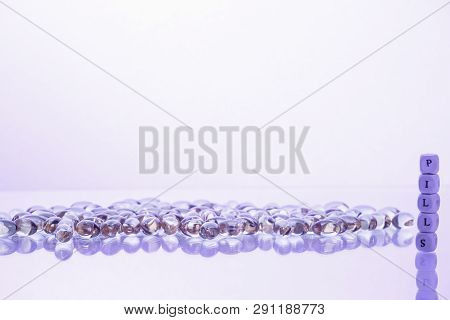 Word Pills From The Letters Of Cubes And Lecithin Gel Pills On Light Background. Soy And Sunflower L