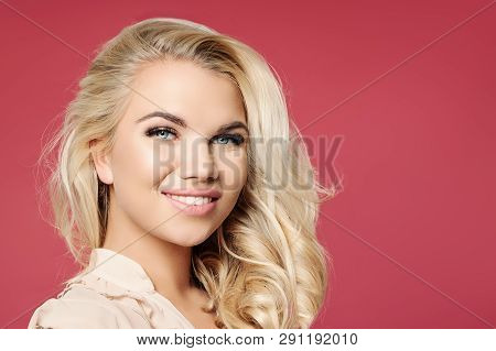 Pretty Woman Face. Girl With Blonde Curly Bob Hairstyle And Cute Smile Smiling Against Colorful Pink