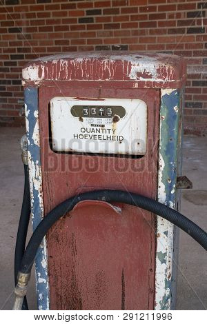 A Close Up View Of A Old White, Blue, Red And Black Antique Unused Petrol Pump Used For Show