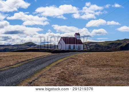 Church In Mountain. Road And Cloudly Sky