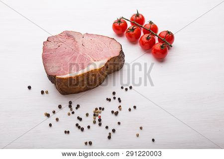 Food, Cuisine And Horsemeat Concept - Close Up Of Delicious Horse Meat With Pepper And Tomatoes, Top