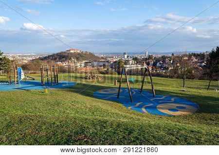 Beautiful Playground With Wooden Swing And Climbing Frames For Children With Spilberk Castle In Back