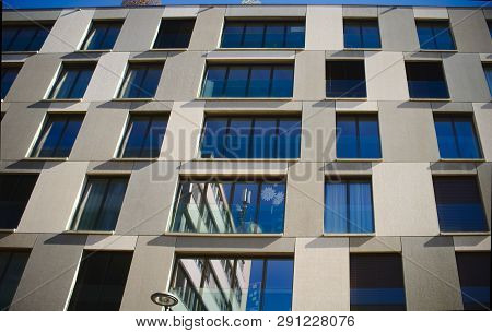 Looking Up To An Urban Window Front Against Blue Sky