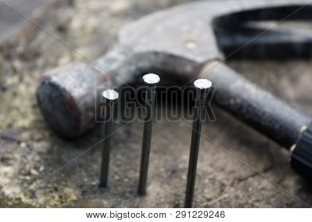 Hammer And Nails On A Wooden Blurred Background