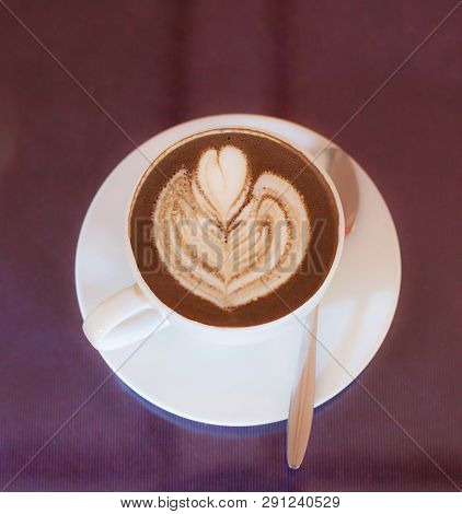 Hot Cappuccino Coffee Decorated With Blooming Flower Froth Art On Steamed Milk Foam In White Cup On 