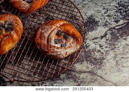 Top View Of Golden Chese Danish Pasties With Blackberries And Powder Sugar