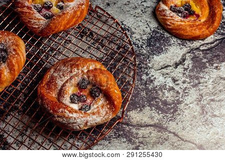 Top View Of Golden Chese Danish Pasties With Blackberries And Powder Sugar