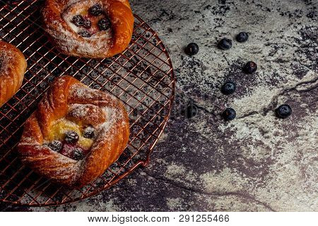 Top View Of Golden Chese Danish Pasties With Blackberries And Powder Sugar
