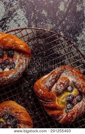 Top View Of Golden Chese Danish Pasties With Blackberries And Powder Sugar