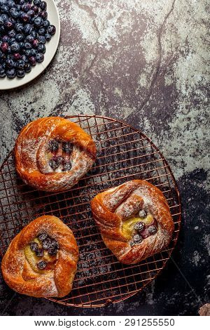Top View Of Golden Chese Danish Pasties With Blackberries And Powder Sugar