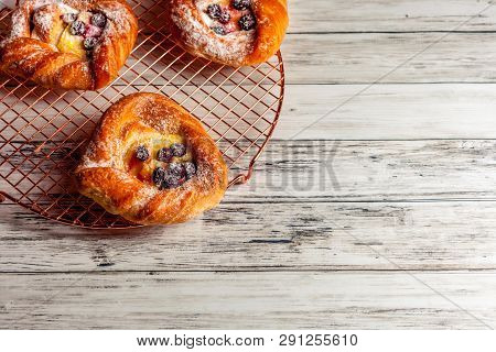 Top View Of Golden Chese Danish Pasties With Blackberries And Powder Sugar