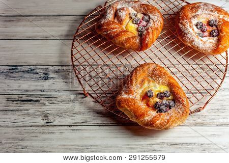 Top View Of Golden Chese Danish Pasties With Blackberries And Powder Sugar