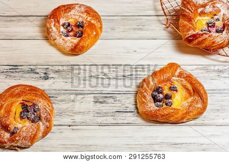 Top View Of Golden Chese Danish Pasties With Blackberries And Powder Sugar