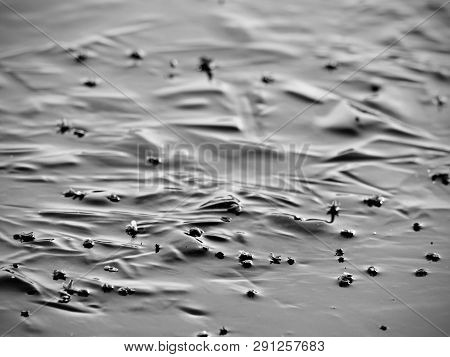 Abstract Surface Of Frozen Lake. Frozen Air In Arctic Ice. Colorful Piece Of Ice With Sun Rays Refle