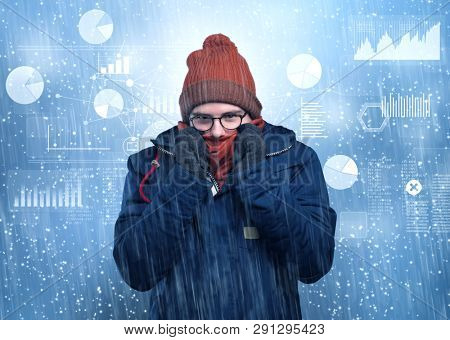 Young businessman shivering with graphs, reports and chart concept